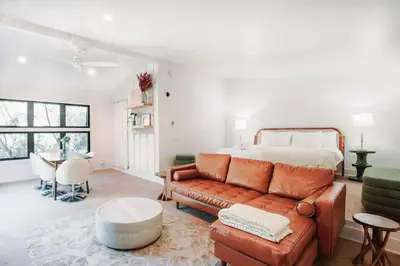 a living room with a couch and a bed at Gorgeous Eccentric Family Home with Cowboy Pool in San Diego