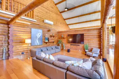 a living room with a couch and a flat screen tv at Red Hawk Ridge SD Mag Design Winner in Alpine