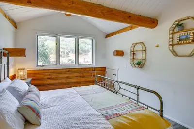 a bedroom with a bed and a window at Red Hawk Ridge SD Mag Design Winner in Alpine