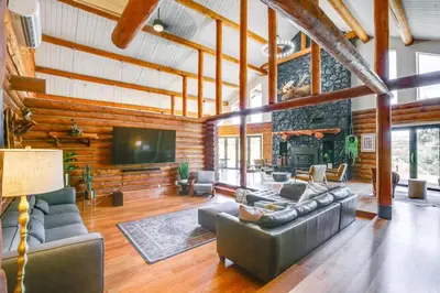 a living room with a couch and a tv and a fireplace at Red Hawk Ridge SD Mag Design Winner in Alpine