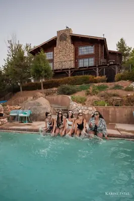 a group of people sitting in a swimming pool at Japatul House w Pool & Spa 5 Star Google Reviews in Alpine