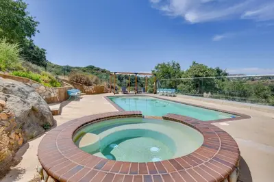 a swimming pool with a brick walkway around it at Japatul House w Pool & Spa 5 Star Google Reviews in Alpine