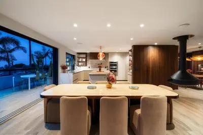 a dining room and kitchen with a table and chairs at Solana Beach Luxury with Panoramic Ocean Views in Solana Beach