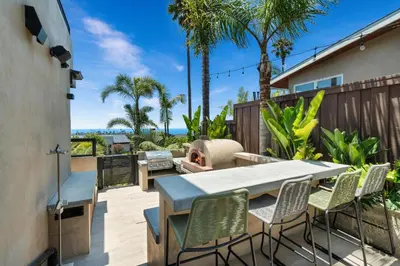 a patio with a table and chairs and a grill at Solana Beach Luxury with Panoramic Ocean Views in Solana Beach