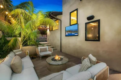a living room with a couch and a fire place at Solana Beach Luxury with Panoramic Ocean Views in Solana Beach