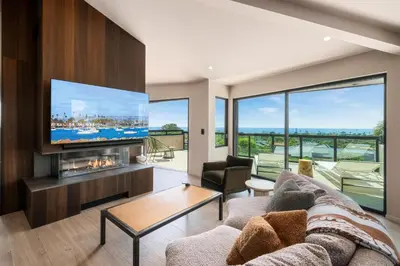 a living room with a couch and a tv at Solana Beach Luxury with Panoramic Ocean Views in Solana Beach