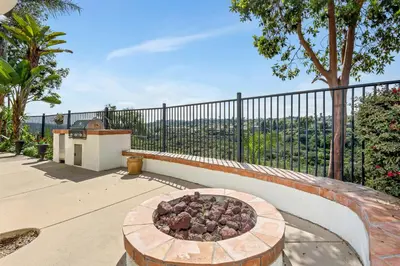 a patio with a fire pit in front of a fence at Luxury Gated Retreat Views Trails & Resort Pool in Carlsbad