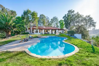 an estate with a swimming pool in front of a house at Fallbrook Hilltop Sanctuary - Pool & Pickleball in Fallbrook