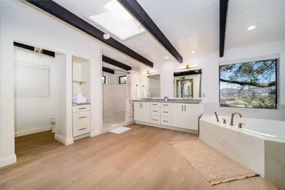 a large bathroom with a tub and a sink at Fallbrook Hilltop Sanctuary - Pool & Pickleball in Fallbrook