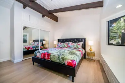 a bedroom with a bed and a mirror at Fallbrook Hilltop Sanctuary - Pool & Pickleball in Fallbrook