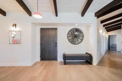 a room with a door and a clock on the wall at Fallbrook Hilltop Sanctuary - Pool & Pickleball in Fallbrook