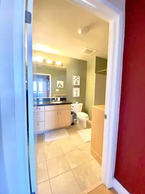 a bathroom with a toilet and a sink at Allura Gaslamp Condo - Office Pool Gym & Parking in San Diego