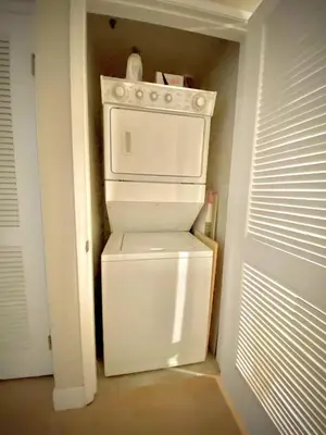 a small kitchen with a white stove in a room at Allura Gaslamp Condo - Office Pool Gym & Parking in San Diego