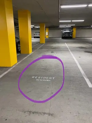 a parking garage with a purple circle on the floor at Allura Gaslamp Condo - Office Pool Gym & Parking in San Diego