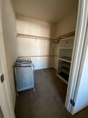 a walk in closet with a cart in it at Allura Gaslamp Condo - Office Pool Gym & Parking in San Diego