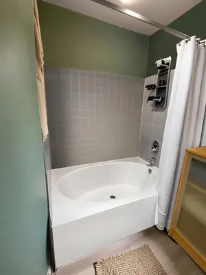 a white bath tub in a bathroom with a shower at Allura Gaslamp Condo - Office Pool Gym & Parking in San Diego