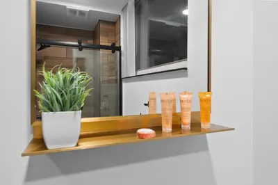a shelf with vases and a plant on it at The Neon Elm Hotel in San Diego