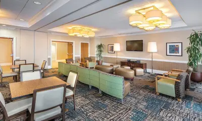 a lobby with a waiting room with tables and chairs at Wyndham Oceanside Pier 2BR Apartment with Resort Access in Oceanside