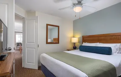 a bedroom with a large bed and a mirror at Wyndham Oceanside Pier 2BR Apartment with Resort Access in Oceanside