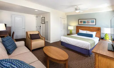 a hotel room with a bed and a couch at Wyndham Oceanside Pier 2BR Apartment with Resort Access in Oceanside