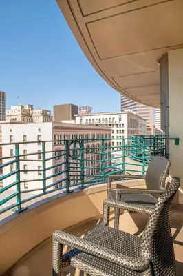 two chairs on a balcony with a view of a city at Wyndham Harbour Lights Studio Apartment with Resort Access in San Diego