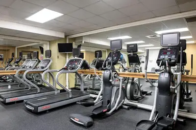 a gym with several rows of tread machines at Wyndham Harbour Lights Studio Apartment with Resort Access in San Diego