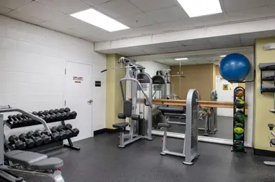 a gym with dumbbells and a table with weights at Wyndham Harbour Lights Studio Apartment with Resort Access in San Diego