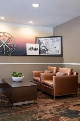a lobby with two leather chairs and a table at Wyndham Harbour Lights Studio Apartment with Resort Access in San Diego