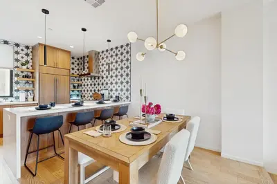 a dining room with a wooden table and chairs at Sea & Stroll Abode in Carlsbad