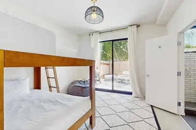 a bedroom with a bunk bed and a window at Sea & Stroll Abode in Carlsbad