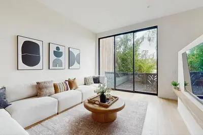 a living room with a couch and a table at Sea & Stroll Abode in Carlsbad