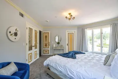 a bedroom with a bed and a large window at Fountainhead Vineyards Manor in Temecula