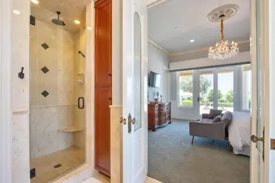 a bathroom with a walk in shower next to a bedroom at Fountainhead Vineyards Manor in Temecula
