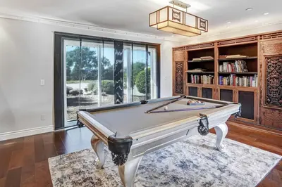 a pool table in a room with a book shelf at Fountainhead Vineyards Manor in Temecula
