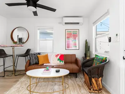 a living room with a couch and a table at Barrio Casita - 2Bd, Central, Parking, EV Charging in San Diego