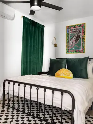 a bedroom with a bed with a green curtain at Barrio Casita - 2Bd, Central, Parking, EV Charging in San Diego