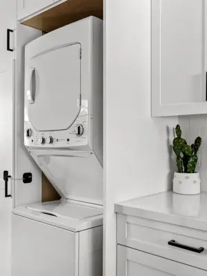 a white kitchen with a washer and dryer at Barrio Casita - 2Bd, Central, Parking, EV Charging in San Diego
