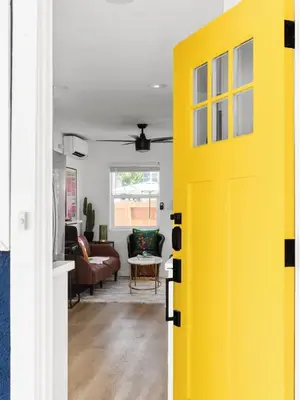 a yellow door leading into a living room at Barrio Casita - 2Bd, Central, Parking, EV Charging in San Diego