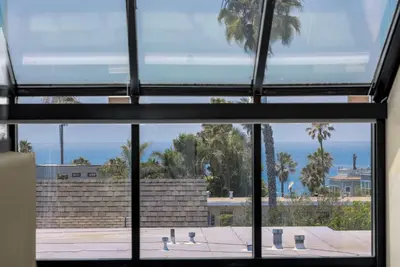 a view of the ocean from a window at The 357 Beach Pad, Renovated, Refined, Steps from the Surf! in San Diego