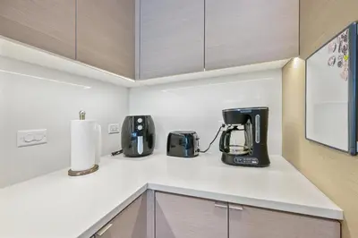 a kitchen with appliances on a white counter top at NEW Upscale Downtown San Diego Stay Queen Bed Pool & Sauna in San Diego