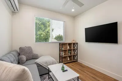a living room with a couch and a flat screen tv at Beautiful cozy home in San Diego in San Diego