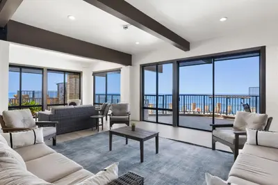 a living room with couches and chairs and large windows at Sandy Wheels - DMST66 in Solana Beach