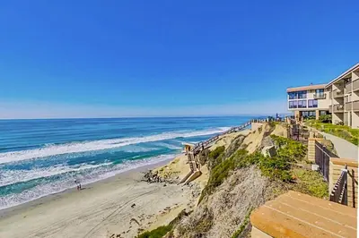 a view of a beach with a building and the ocean at Sandy Wheels - DMST66 in Solana Beach