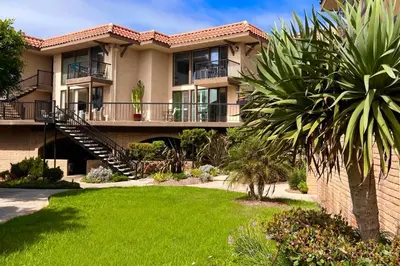 a large apartment building with a green yard at Sandy Wheels - DMST66 in Solana Beach