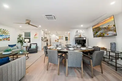 a dining room and living room with a table and chairs at La Jolla Panoramic Ocean Retreat with Rooftop in San Diego