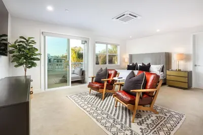 a bedroom with a bed and a table and chairs at La Jolla Panoramic Ocean Retreat with Rooftop in San Diego