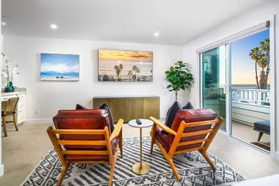 a living room with two chairs and a table at La Jolla Panoramic Ocean Retreat with Rooftop in San Diego