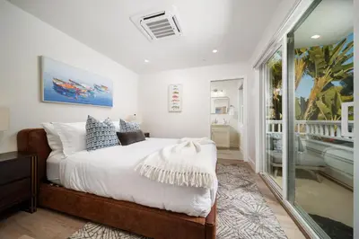 a bedroom with a large bed and a window at La Jolla Panoramic Ocean Retreat with Rooftop in San Diego