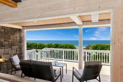 a balcony with a table and chairs and a view of the ocean at Pacific Beach Oceanfront Compound with Casita in San Diego