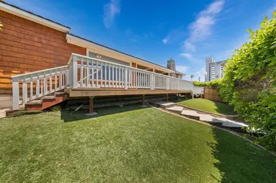 a deck on a house with a grass yard at Pacific Beach Oceanfront Compound with Casita in San Diego